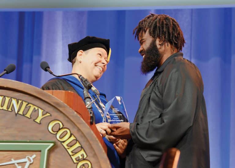 President Royal presents the  Distinguished Service Award to Mychal Connolly at HCC’s 75th annual Commencement June 4, 2022.