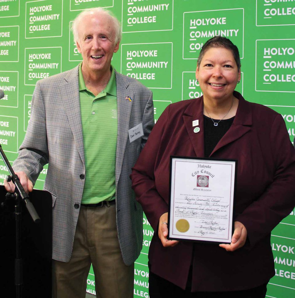 Holyoke city councilor David K. Bartley presents President Royal with an official resolution from the Holyoke City Council.