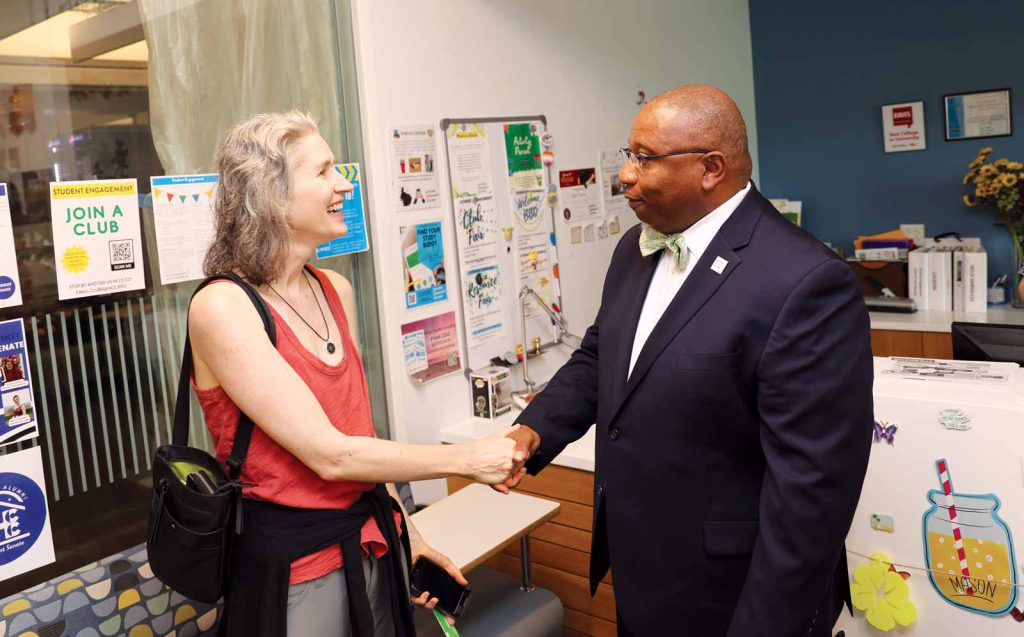 President Timmons greets new student Kristen Thiel on his first-day tour of campus.