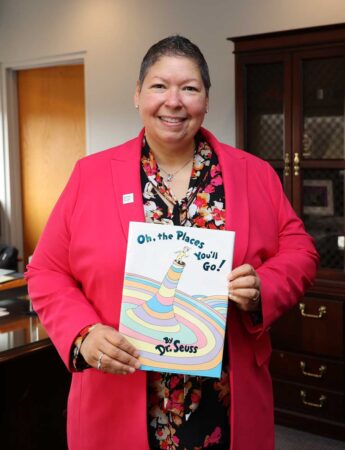 May 2022: President Royal, an avid reader, holds one of her favorite books.