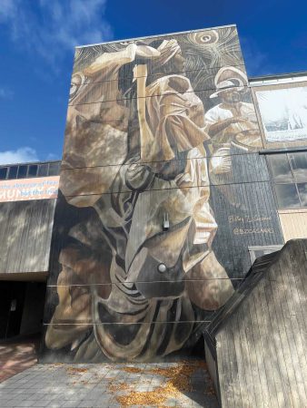 Mural in the HCC courtyard, featuring a likeness of a bomba dancer and drummer