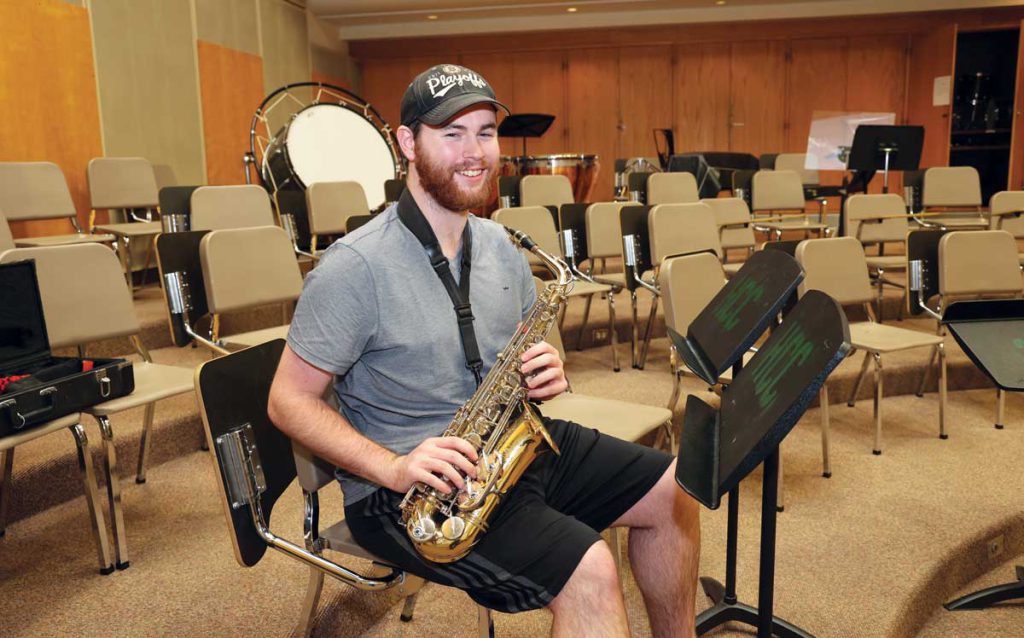 Tom (“Zac Dune”) Dulac practices his saxophone last spring at HCC