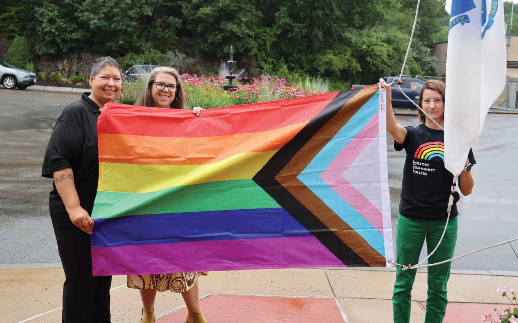 Christina Royal, left, is joined by her partner Karen MacGeorge, and Renee Tastad, HCC assistant vice president of student affairs and dean of enrollment management, right, for the raising of the Pride flag on Royal’s last day as HCC president.