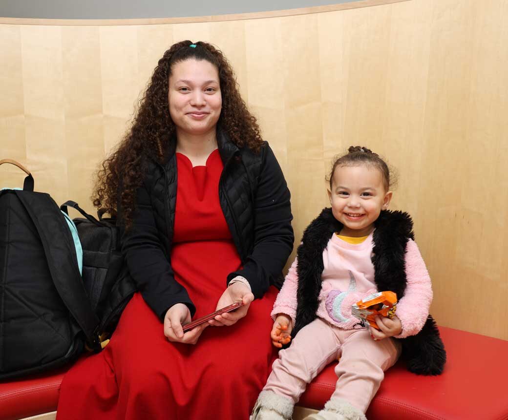 HCC STEM Scholar Alondra Serrano sits with her daughter, Anna, after collecting her from the Itsy Bitsy Child Watch.