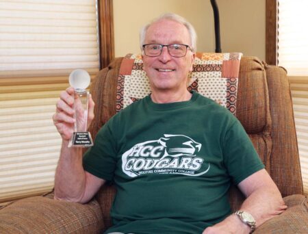 Terry Murphy ’68, ’77 holds a trophy recognizing his induction into the Western Massachusetts Baseball Hall of Fame.
