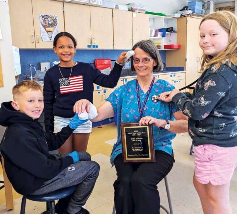 Nurse Jean celebrates her award with students at Hatfield Elementary School.