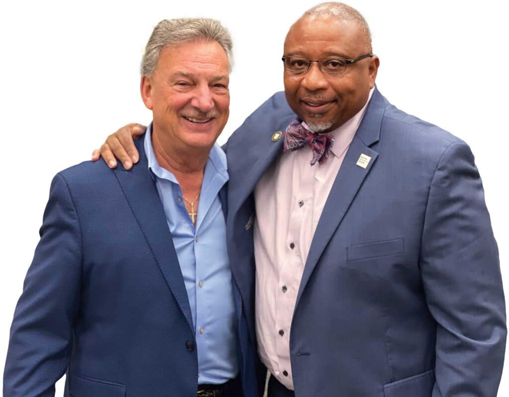 HCC Foundation board member Ted Hebert ’71, left, and President George Timmons.