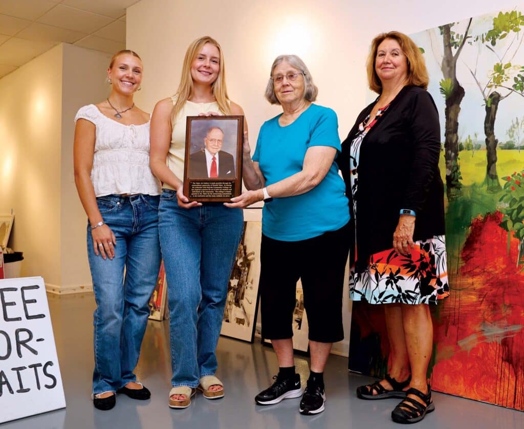 Members of the Taber family visited the Taber Art Gallery on Aug. 25, on the 25th anniversary of the gallery’s opening in 2020. Donald Taber’s great-granddaughter, Haley Snyder, and daughter, Ann Nugent, hold a portrait of Donald Taber, flanked by his great-granddaughter Morgan Snyder, far left, and granddaughter, Laura McGrew, far right.