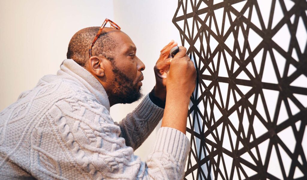 HCC Visual Art Professor Raishad Glover works on an installation for a solo show in 2024