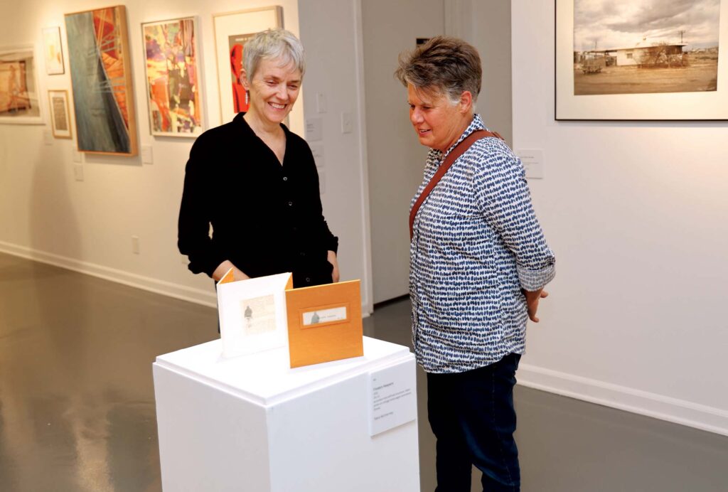 Guests view the gallery’s 25th anniversary “Milestone” exhibit in September 2025.